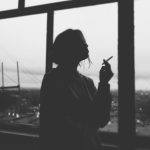 silhouette of woman smoking cigarette