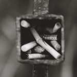 grayscale photography of cigarette butts in ashtray